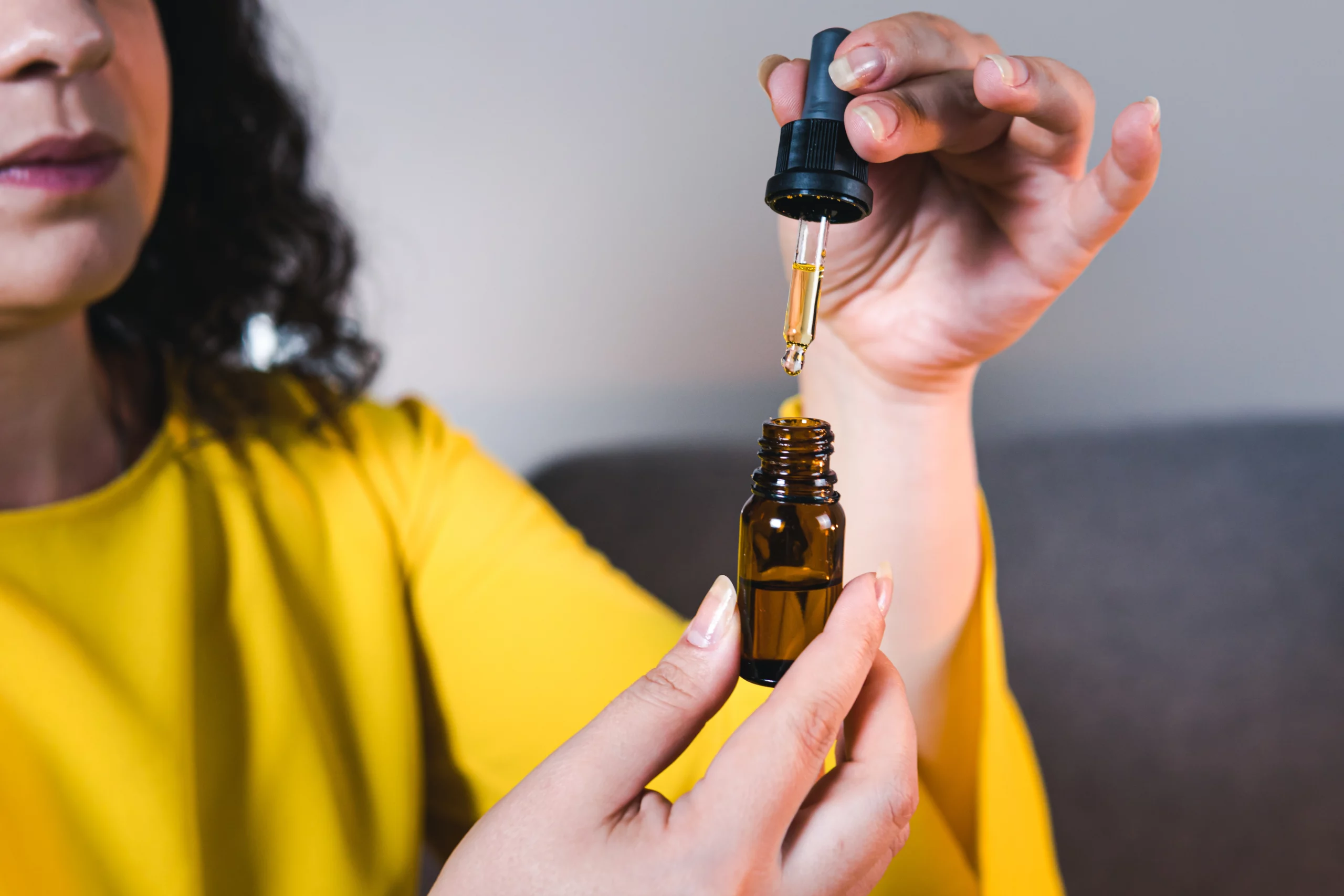 Lady Showcasing CBD Tincture - Nature